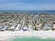 Gorgeous aerial view of coastal property with pristine white sand beach, clear turquoise water, and charming neighborhood setting at 101 66Th St # 1, Holmes Beach, FL 34217