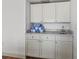 Neutral-colored bathroom with marble countertops and blue and white decorative towels at 101 66Th St # 1, Holmes Beach, FL 34217