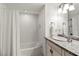 Well-lit bathroom with tub-shower combo, tile, and a granite sink counter at 101 66Th St # 1, Holmes Beach, FL 34217