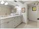 This is a clean and spacious bathroom with marble counters, double sinks, and hexagon tiled flooring at 101 66Th St # 1, Holmes Beach, FL 34217