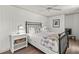 Bedroom features a comfortable bed, modern ceiling fan, and light wood flooring at 101 66Th St # 1, Holmes Beach, FL 34217
