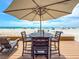 Outdoor dining area on a wooden deck overlooking a beautiful beach with clear ocean views at 101 66Th St # 1, Holmes Beach, FL 34217