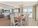 Dining room with seating for six with views of the ocean and living area at 101 66Th St # 1, Holmes Beach, FL 34217