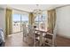 Dining room with seating for six and large windows with views of the beach at 101 66Th St # 1, Holmes Beach, FL 34217