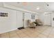 Inviting hallway with tile flooring, neutral armchairs, and beach-themed decor for a calming entry experience at 101 66Th St # 1, Holmes Beach, FL 34217