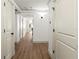 Bright hallway featuring wood-look flooring, white trim, and access to multiple rooms for easy navigation at 101 66Th St # 1, Holmes Beach, FL 34217