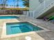 Relaxing outdoor hot tub with stylish tile and a community pool, perfect for unwinding with friends and Gathering at 101 66Th St # 1, Holmes Beach, FL 34217