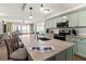Well-equipped kitchen with an island, modern lighting, and easy access to the living room and beach views at 101 66Th St # 1, Holmes Beach, FL 34217
