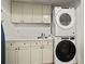 Functional laundry area with a stackable washer and dryer, plus ample storage and counter space at 101 66Th St # 1, Holmes Beach, FL 34217