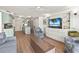 Open concept living room and kitchen with breakfast bar seating and light colored cabinets at 101 66Th St # 1, Holmes Beach, FL 34217