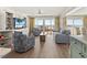 Inviting living room features a wall-mounted TV and beach views through large windows for relaxation and enjoyment at 101 66Th St # 1, Holmes Beach, FL 34217