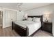 Comfortable main bedroom with a dark wood bed frame, soft lighting, and neutral decor at 101 66Th St # 1, Holmes Beach, FL 34217