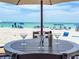 Inviting outdoor table set on a deck overlooking the beach, perfect for enjoying beach views at 101 66Th St # 1, Holmes Beach, FL 34217