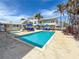 Inviting outdoor community pool and hot tub with lounge chairs and tropical landscaping for relaxation at 101 66Th St # 1, Holmes Beach, FL 34217