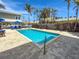 Inviting outdoor community pool with lounge chairs, umbrellas, and tropical palm trees offers a relaxing retreat at 101 66Th St # 1, Holmes Beach, FL 34217