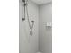 Modern shower featuring gray tiled walls, sleek fixtures, and mounted shampoo and soap dispensers at 101 66Th St # 1, Holmes Beach, FL 34217