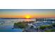 Scenic aerial shot of a coastline with a marina, yachts, and buildings bathed in the warm glow of sunset at 101 S Gulfstream Ave # 5J, Sarasota, FL 34236
