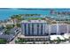 Stunning aerial view of the waterfront condominium building with boat docks and open ocean in the background at 101 S Gulfstream Ave # 5J, Sarasota, FL 34236