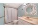 Bathroom with vanity, toilet, and shower-tub combo has white fixtures and neutral walls at 101 S Gulfstream Ave # 5J, Sarasota, FL 34236
