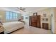 Sunny bedroom is bright and airy and features a large window with shutter blinds and beautiful decor at 101 S Gulfstream Ave # 5J, Sarasota, FL 34236