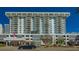 High-rise condo building features stacked balconies and modern architecture against a blue sky at 101 S Gulfstream Ave # 5J, Sarasota, FL 34236