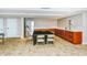Clubhouse kitchen area with dining table, stainless steel refrigerator and wooden cabinets at 101 S Gulfstream Ave # 5J, Sarasota, FL 34236