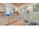 Bright kitchen has white appliances and cabinets, breakfast area with table, and outside view at 101 S Gulfstream Ave # 5J, Sarasota, FL 34236