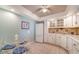 Eat-in kitchen features white cabinets, appliances, tile backsplash, and a quaint breakfast table with seating at 101 S Gulfstream Ave # 5J, Sarasota, FL 34236