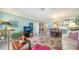 Open concept living room featuring tile flooring, bright walls, dining area, and cozy furnishings at 101 S Gulfstream Ave # 5J, Sarasota, FL 34236