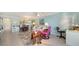 Bright living room with blue walls, tiled floors, cozy furnishings, and a dining area at 101 S Gulfstream Ave # 5J, Sarasota, FL 34236