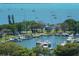 Aerial view of a vibrant marina with boats docked in the clear blue waters at 101 S Gulfstream Ave # 5J, Sarasota, FL 34236