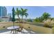 Beautiful patio with tropical landscaping and views of the ocean and surrounding buildings at 101 S Gulfstream Ave # 5J, Sarasota, FL 34236