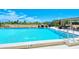 Community pool with grilling area and dining under a wooden pergola at 101 S Gulfstream Ave # 5J, Sarasota, FL 34236