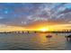 Picturesque waterfront view showcasing a bridge and sailboats at sunset with vibrant sky reflections on calm water at 101 S Gulfstream Ave # 5J, Sarasota, FL 34236