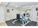 Well-equipped workout room featuring weights, bench, exercise bike, and mirrored wall at 101 S Gulfstream Ave # 5J, Sarasota, FL 34236