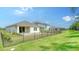 Manicured backyard showing the fencing around the properties and green lawn at 10105 Canaveral Cir, Sarasota, FL 34241