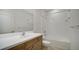 Well-lit bathroom featuring a shower-tub combo and a single sink vanity at 10105 Canaveral Cir, Sarasota, FL 34241