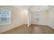 Bright, airy bedroom with hardwood flooring, ample natural light, and a neutral color palette at 10105 Canaveral Cir, Sarasota, FL 34241