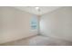 Unfurnished bedroom featuring neutral walls and carpet, a ceiling fan and a large window at 10105 Canaveral Cir, Sarasota, FL 34241