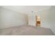 Spacious bedroom with neutral carpet, closet, and doorway leading to a bathroom at 10105 Canaveral Cir, Sarasota, FL 34241