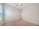 Neutral bedroom with plush carpet, window and closet at 10105 Canaveral Cir, Sarasota, FL 34241