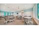 Spacious clubhouse includes ample seating, ceiling fans, and a view of a billiards room at 10105 Canaveral Cir, Sarasota, FL 34241