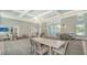 Open clubhouse boasts ample seating and tables, complemented by tasteful decor and bright, airy windows at 10105 Canaveral Cir, Sarasota, FL 34241