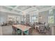 Beautiful clubhouse featuring elegant seating, tables, and coffered ceilings, with a view of the exterior landscape at 10105 Canaveral Cir, Sarasota, FL 34241