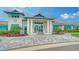 Stately clubhouse with elegant entrance, columns, and lush landscaping at 10105 Canaveral Cir, Sarasota, FL 34241