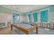 Game room with a billiards table, multiple seating areas, and neutral decor and flooring at 10105 Canaveral Cir, Sarasota, FL 34241