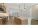 Modern kitchen boasts stainless steel appliances and a large island with pendant lighting, perfect for entertaining at 10105 Canaveral Cir, Sarasota, FL 34241