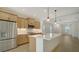 Modern kitchen boasts stainless steel appliances, ample cabinetry, and a large central island with pendant lighting at 10105 Canaveral Cir, Sarasota, FL 34241