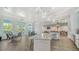 Entertainers kitchenette with pendant lighting, ample seating, and tiled floors at 10105 Canaveral Cir, Sarasota, FL 34241