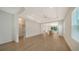 Bright, open living room with wood floors seamlessly connecting to kitchen area, offering an inviting and modern living space at 10105 Canaveral Cir, Sarasota, FL 34241